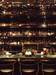 an opulent bar with a mirrored ceiling