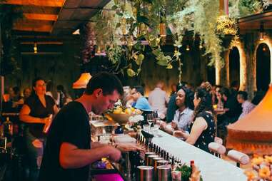 a bartender pouring drinks in a crowded bar