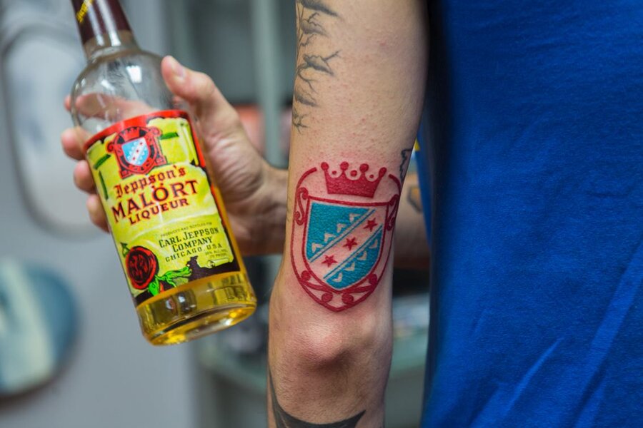 A Girl with a Bad Appearance Holds a Bottle of Alcohol Near Her