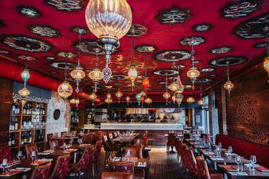 an opulent restaurant dining room with chandeliers