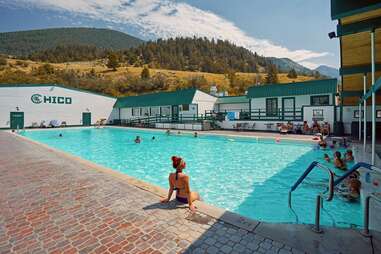 people lounging in a mountainside hot spring