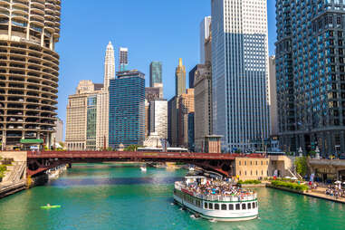 people on a river cruise through a city