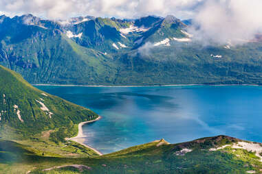 birds eye view of large mountains and a sea