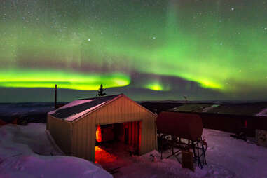 a small cabin beneath the northern lights