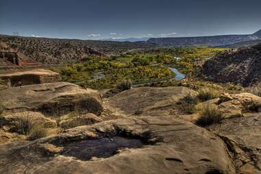 view across desert cliffs and a winding river