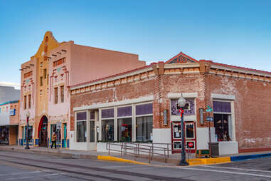 an old adobe building on a main street