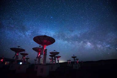 massive satellites beneath a starry night sky