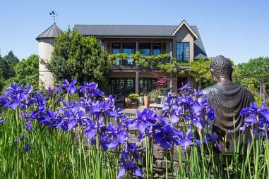 flowers surrounding a large farmhouse