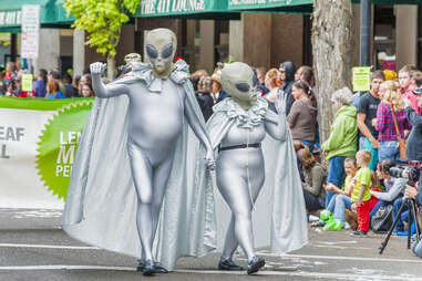 people dressed as aliens walking in a parade