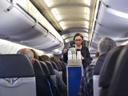 Flight Attendant Sitting In A Jump Seat With A Telephone High-Res Stock  Photo - Getty Images