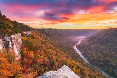 a view of autumn leaves on a river gorge