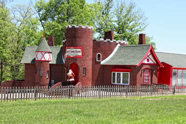a christmas museum with a santa statue out front