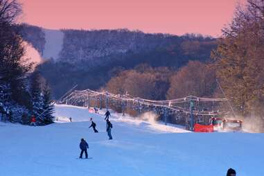 people skiing at sunset