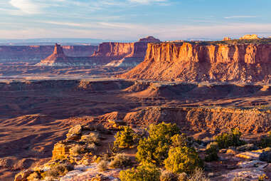 Golden Hour Light on large rock formation Candlestick Tower and the Island in the Sky from the end of Grand Viewpoint in Canyonlands National Park, Utah