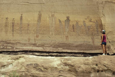 a hiker looking at pictographs