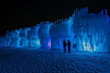 people standing in front of an ice castle