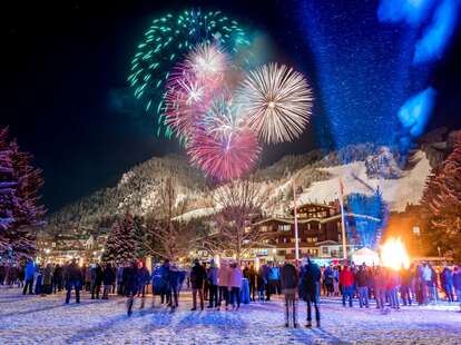 fireworks over a winter mountain town