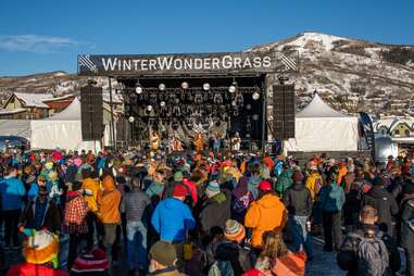 people at an outdoor concert in a snowy mountain town