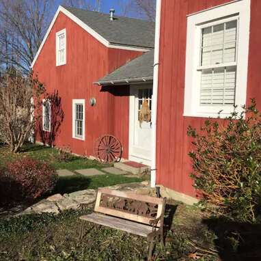 A restored New England milk barn with a pool and hot tub