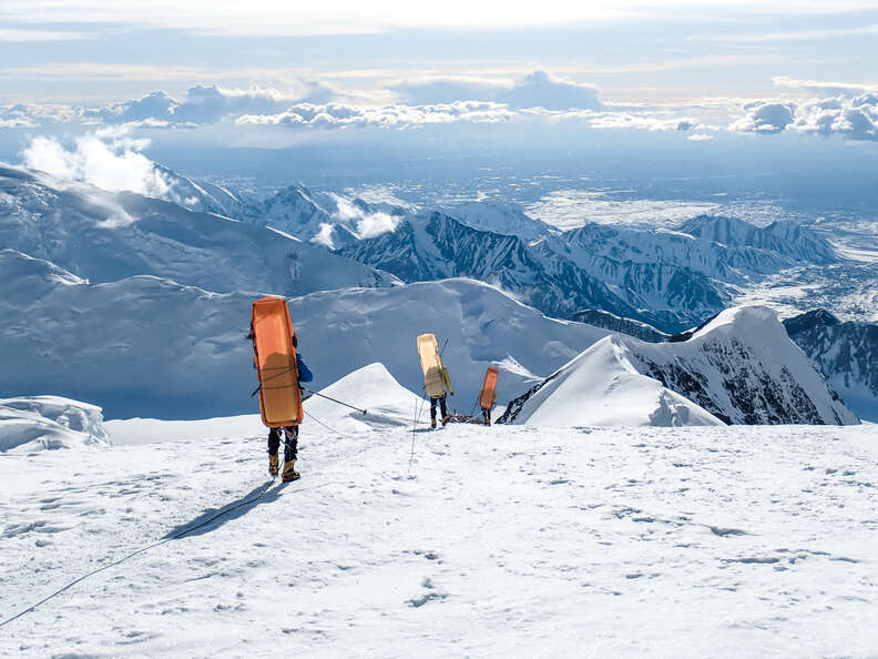 hikers descending a snowy mountain