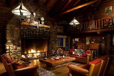 a woodland cabin with a roaring fireplace