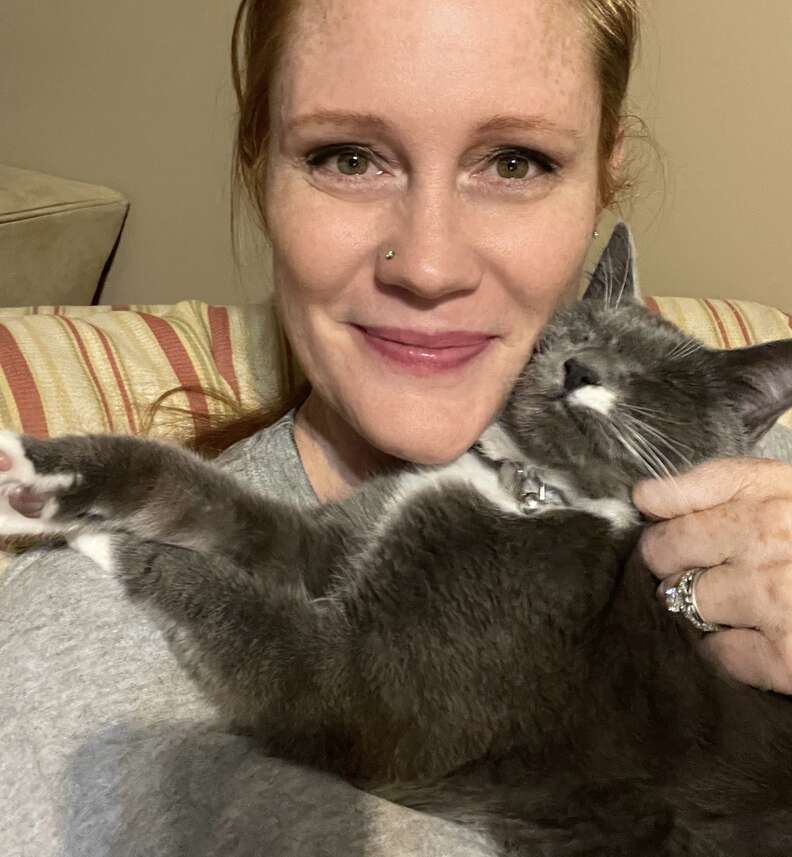cat cuddles with mom