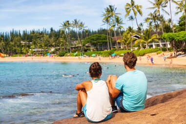 Hawaii beach summer lifestyle young people relaxing in Kauai