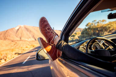 feet hanging out of a car window