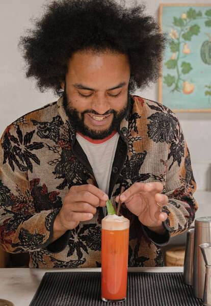 Clavel bar manager Andre Barnhill garnishes a cocktail