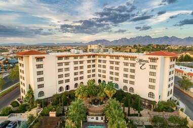 hotel in the desert surrounded by palm trees and mountains