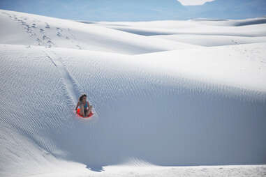 person sand sledding