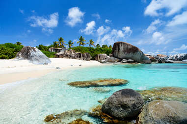 a beautiful beach covered in boulders