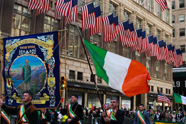 Irish flag flown during St. Patricks Day parade in NYC along with the flag of the United States