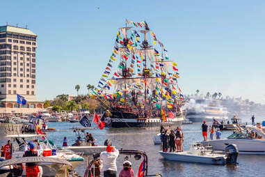 people on boats around a pirate ship