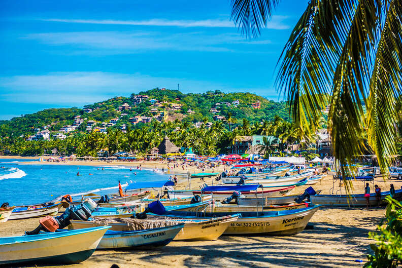 beautiful beach town with mountains in the distance