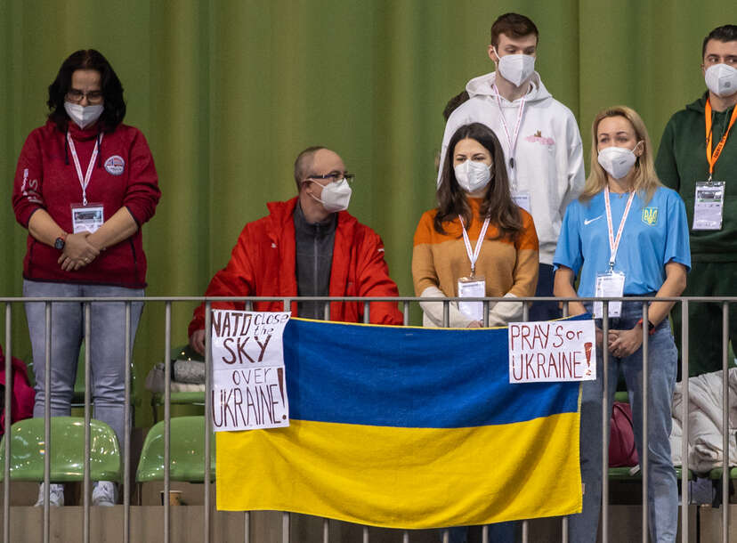 Russian gymnast stands on the podium with symbol supporting