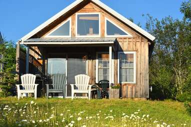 Sunny cabin surrounded by apple trees