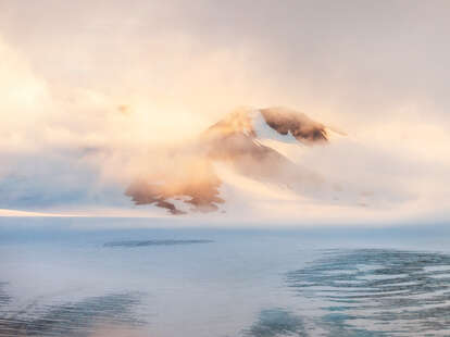 morning near a misty mountain surrounded by water and ice