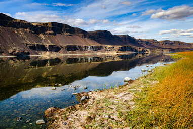 a river near mountains and open plains