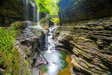 a waterfall near a natural bridge