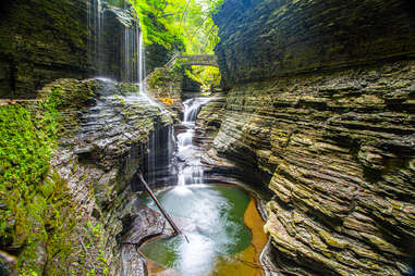 a waterfall near a natural bridge