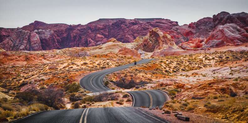 a car driving through a beautiful red rock canyon