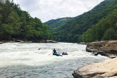 white water rafters sailing down a rough river