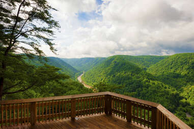 an observation desk overlooking a river and forest