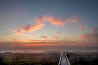 a boardwalk leading out to sea