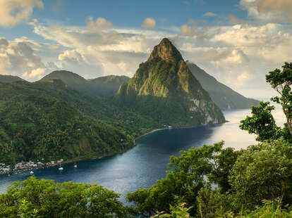 View of the Pitons mountains behind rainforest and bay of Soufrière