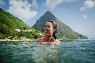 A woman swimming at Jalousie Beach in Soufriere, St. Lucia