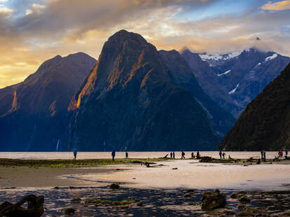 People in the beach at the Milford Sound, New Zealand.