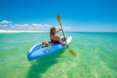 person kayaking through beautiful ocean water