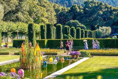 people wandering through a beautiful Victorian garden
